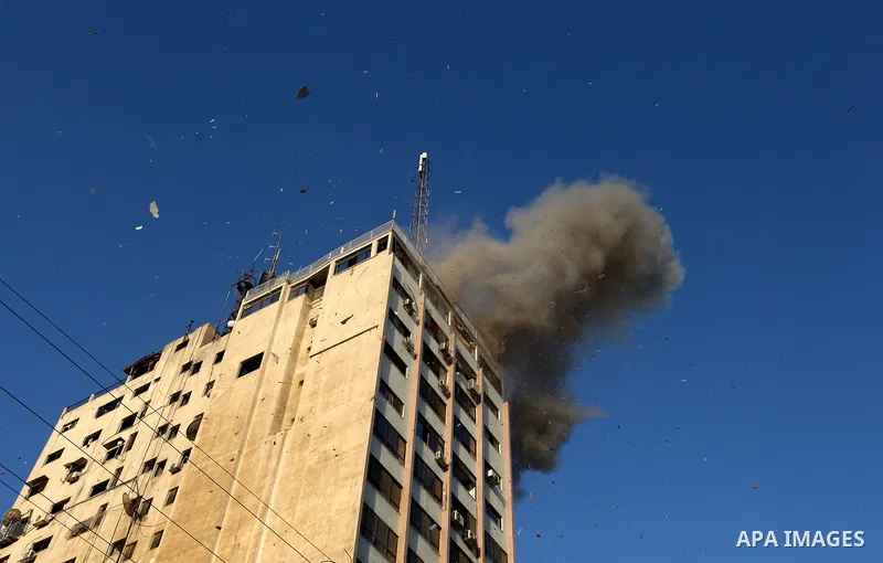 Smoke rises after an Israeli air strike on an office of Hamas television channel Al-Aqsa in Gaza City on November 18, 2012. An Israeli air strike hit a Gaza City media building on November 18, injuring at least six journ...