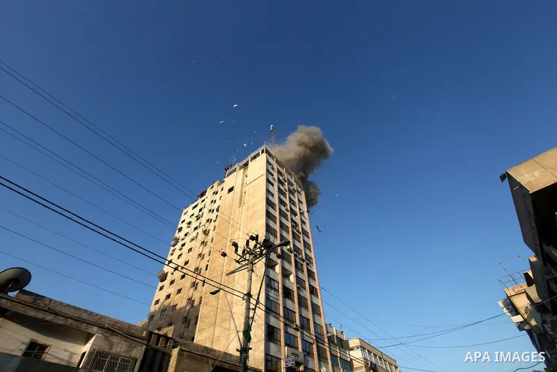 Smoke rises after an Israeli air strike on an office of Hamas television channel Al-Aqsa in Gaza City on November 18, 2012. An Israeli air strike hit a Gaza City media building on November 18, injuring at least six journ...