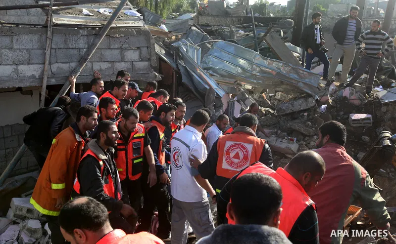 Palestinian civil defence staff carry a survivor on a stretcher after he was pulled out from under the rubble of a destroyed house following an Israeli air strike on Gaza City on November 18, 2012. Fresh Israeli air stri...