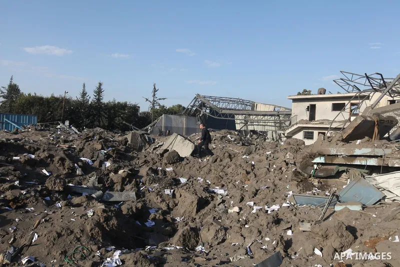A Palestinian man inspects the damage on a rubble of a destroyed house after it was damaged during an Israeli air strike on Gaza City on November 18, 2012. Fresh Israeli air strikes hit a Gaza City media centre and homes...