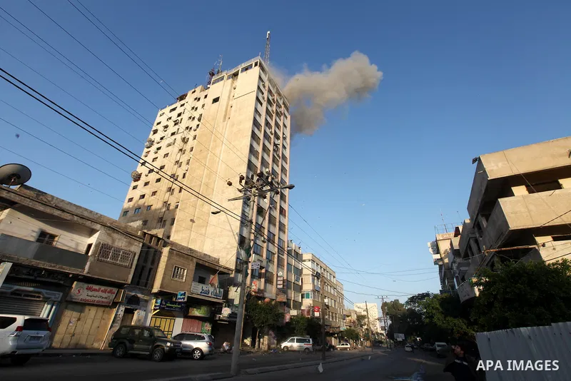 Smoke rises after an Israeli air strike on an office of Hamas television channel Al-Aqsa in Gaza City on November 18, 2012. An Israeli air strike hit a Gaza City media building on November 18, injuring at least six journ...