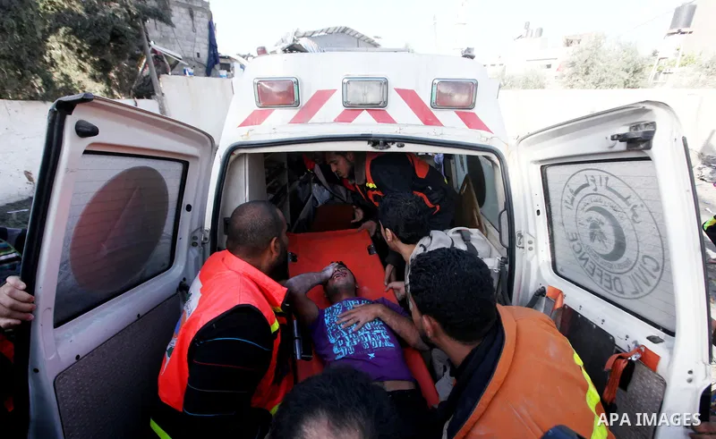 Palestinian civil defence staff carry a survivor on a stretcher after he was pulled out from under the rubble of a destroyed house following an Israeli air strike on Gaza City on November 18, 2012. Fresh Israeli air stri...