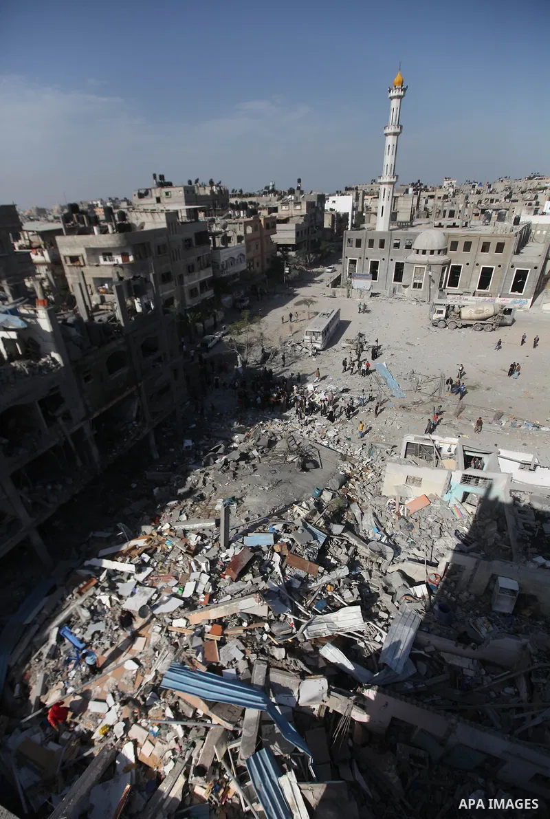 Palestinians survey the remains of a destroyed a house after Israeli air strike in Beit Lahiya town in the northern Gaza strip on, 18 November 2012. Fresh Israeli air strikes hit a Gaza City media centre and homes in nor...