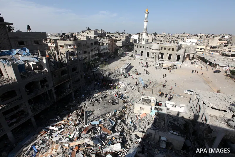 Palestinians survey the remains of a destroyed a house after Israeli air strike in Beit Lahiya town in the northern Gaza strip on, 18 November 2012. Fresh Israeli air strikes hit a Gaza City media centre and homes in nor...