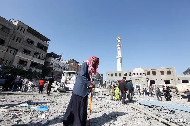 A Palestinian man walks near the remains of a destroyed a house after Israeli air strike in Beit Lahiya town in the northern Gaza strip on, 18 November 2012. Fresh Israeli air strikes hit a Gaza City media centre and hom...