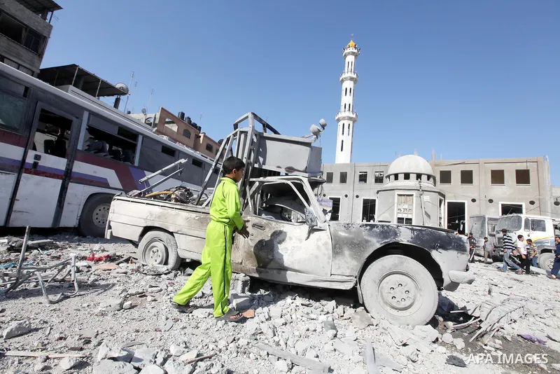 Palestinians survey the remains of a destroyed a house after Israeli air strike in Beit Lahiya town in the northern Gaza strip on, 18 November 2012. Fresh Israeli air strikes hit a Gaza City media centre and homes in nor...