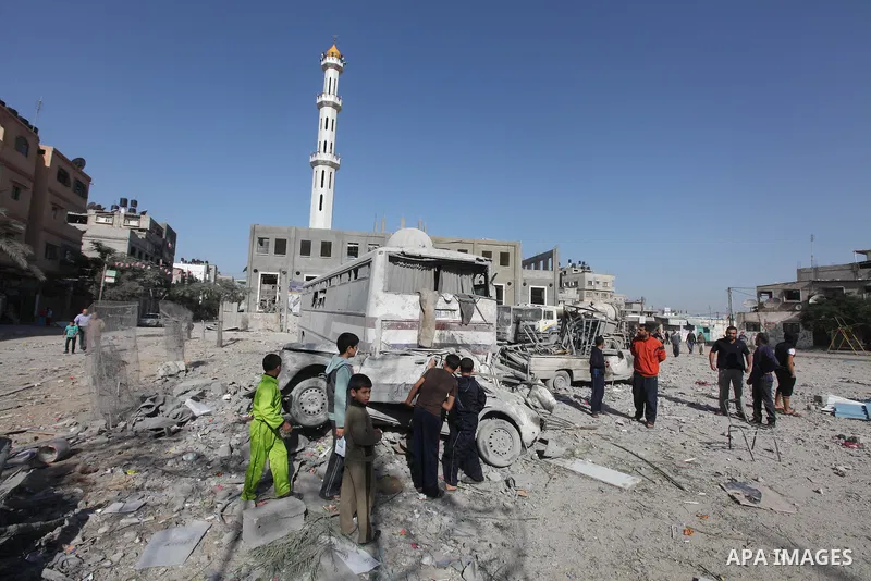 Palestinians survey the remains of a destroyed a house after Israeli air strike in Beit Lahiya town in the northern Gaza strip on, 18 November 2012. Fresh Israeli air strikes hit a Gaza City media centre and homes in nor...