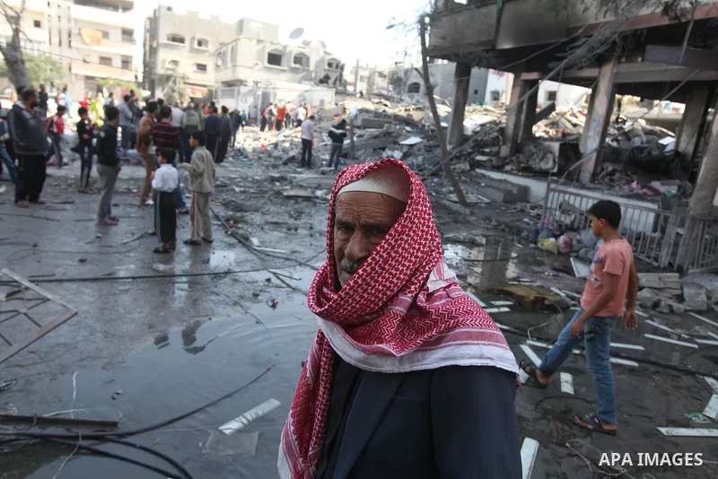 A Palestinian man walks near the remains of a destroyed a house after Israeli air strike in Beit Lahiya town in the northern Gaza strip on, 18 November 2012. Fresh Israeli air strikes hit a Gaza City media centre and hom...