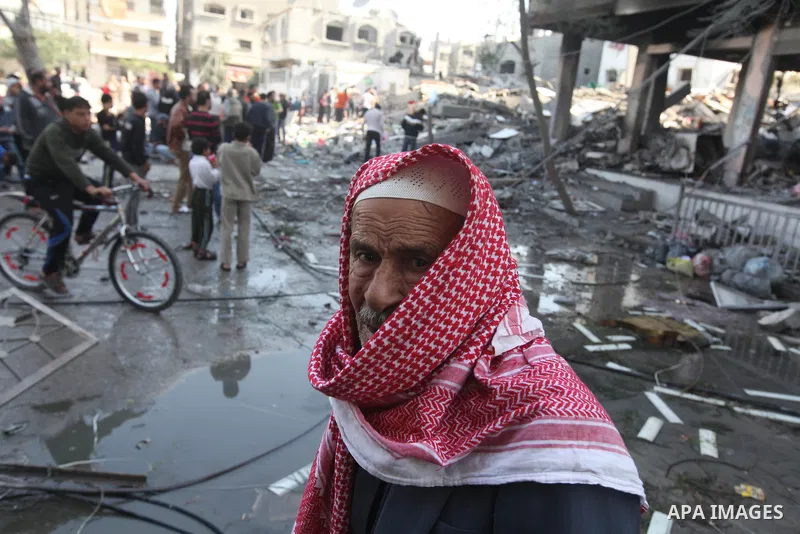 A Palestinian man walks near the remains of a destroyed a house after Israeli air strike in Beit Lahiya town in the northern Gaza strip on, 18 November 2012. Fresh Israeli air strikes hit a Gaza City media centre and hom...