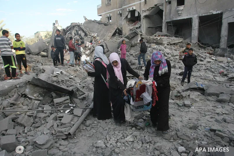 Palestinians search in the rubble of their destroyed homes following Israeli air strikes on the southern Gaza Strip town of Rafah on November 18, 2012. Israeli war planes hit a Gaza City media centre and homes in norther...