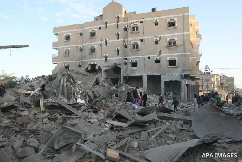 Palestinians search in the rubble of their destroyed homes following Israeli air strikes on the southern Gaza Strip town of Rafah on November 18, 2012. Israeli war planes hit a Gaza City media centre and homes in norther...