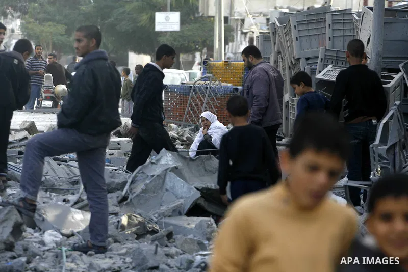 Palestinians look at their destroyed homes following Israeli air strikes on the southern Gaza Strip town of Rafah on November 18, 2012. Israeli war planes hit a Gaza City media centre and homes in northern Gaza in the ea...