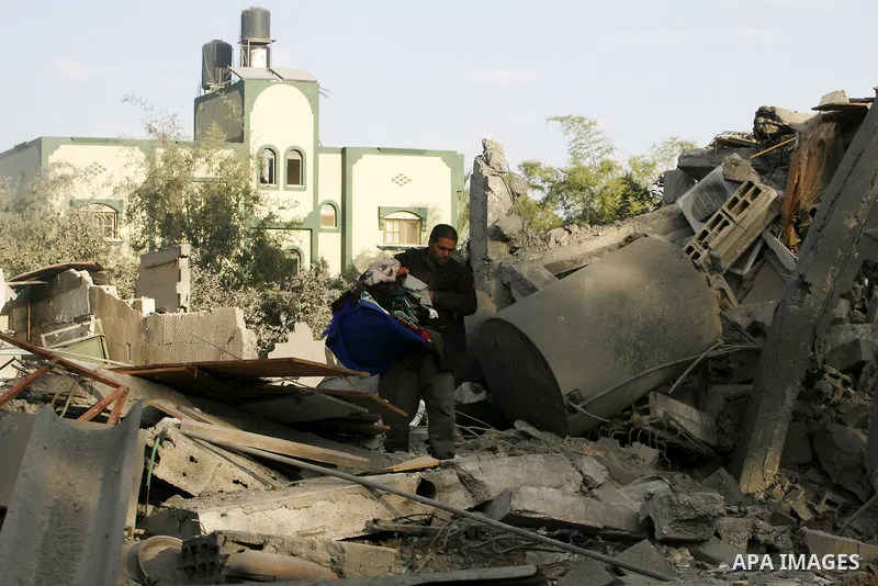 A Palestinian man searches in the rubble of his destroyed home following Israeli air strikes on the southern Gaza Strip town of Rafah on November 18, 2012. Israeli war planes hit a Gaza City media centre and homes in nor...