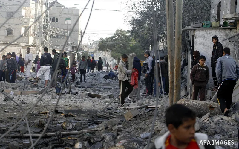 Palestinians look at their destroyed homes following Israeli air strikes on the southern Gaza Strip town of Rafah on November 18, 2012. Israeli war planes hit a Gaza City media centre and homes in northern Gaza in the ea...