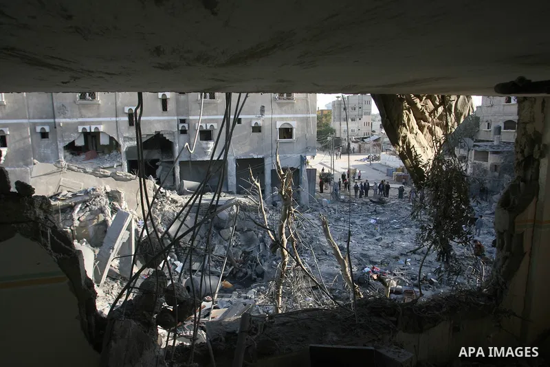 Palestinians search in the rubble of their destroyed homes following Israeli air strikes on the southern Gaza Strip town of Rafah on November 18, 2012. Israeli war planes hit a Gaza City media centre and homes in norther...