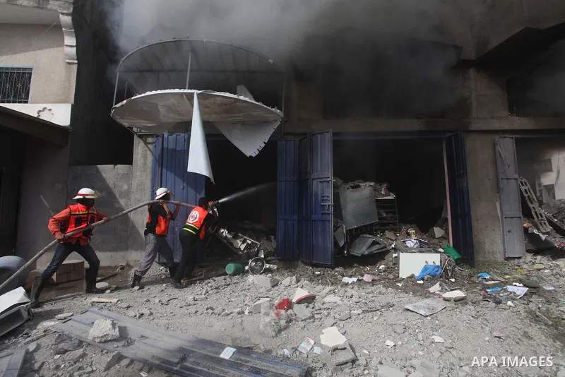 Palestinian firefighters extinguish a fire after an Israeli air strike on a house in al-Shijaia in the east of Gaza city November 18, 2012. Israel bombed militant targets in Gaza for a fifth straight day on Sunday, launc...