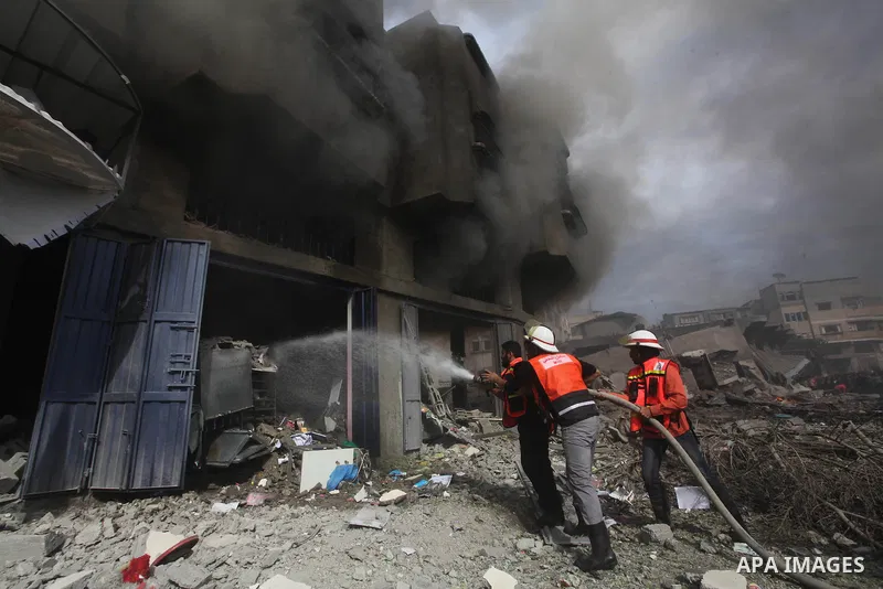 Palestinian firefighters extinguish a fire after an Israeli air strike on a house in al-Shijaia in the east of Gaza city November 18, 2012. Israel bombed militant targets in Gaza for a fifth straight day on Sunday, launc...