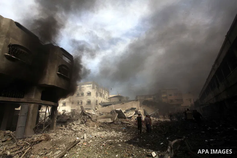 Palestinians survey the remains of a destroyed a house after Israeli air strike in al-Shijaia in the east of Gaza city on, 18 November 2012. Israel bombed militant targets in Gaza for a fifth straight day on Sunday, laun...