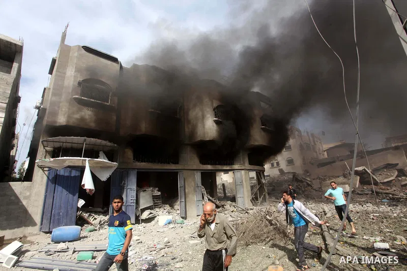 Palestinians survey the remains of a destroyed a house after Israeli air strike in al-Shijaia in the east of Gaza city on, 18 November 2012. Israel bombed militant targets in Gaza for a fifth straight day on Sunday, laun...
