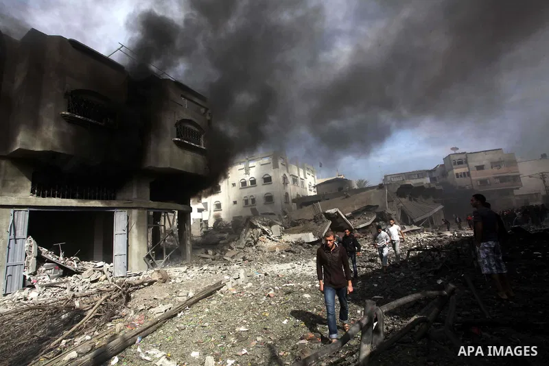 Palestinians survey the remains of a destroyed a house after Israeli air strike in al-Shijaia in the east of Gaza city on, 18 November 2012. Israel bombed militant targets in Gaza for a fifth straight day on Sunday, laun...