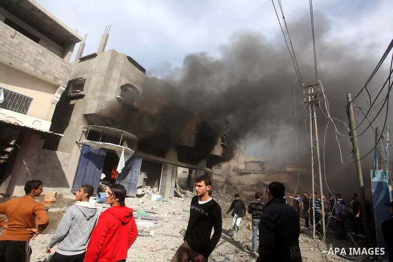 Palestinians survey the remains of a destroyed a house after Israeli air strike in al-Shijaia in the east of Gaza city on, 18 November 2012. Israel bombed militant targets in Gaza for a fifth straight day on Sunday, laun...