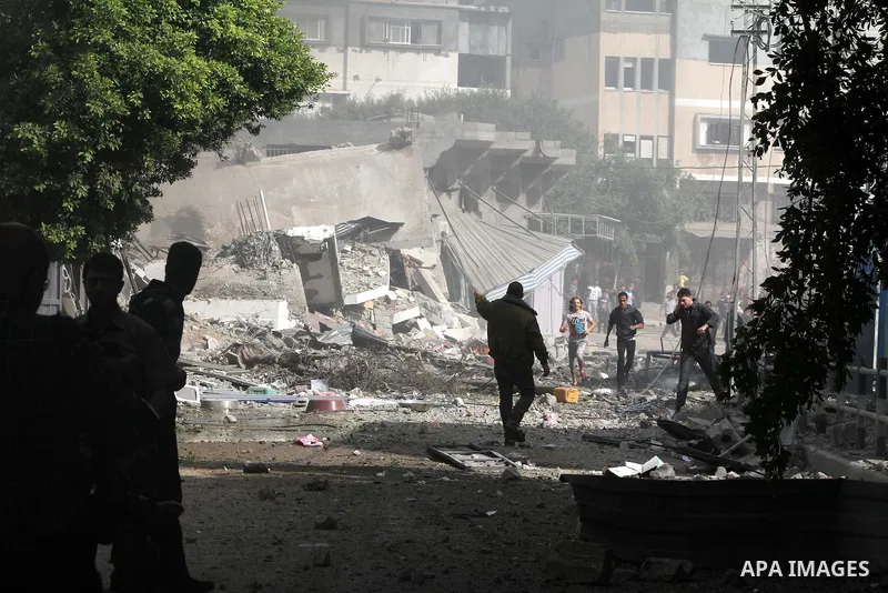 Palestinians survey the remains of a destroyed a house after Israeli air strike in al-Shijaia in the east of Gaza city on, 18 November 2012. Israel bombed militant targets in Gaza for a fifth straight day on Sunday, laun...