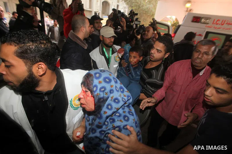 A wounded Palestinian woman arrives to Al-Shifa hospital in Gaza City on November 18, 2012. An Israeli air strike hit a Gaza City media building on November 18, injuring at least six journalists, as a separate raid in no...