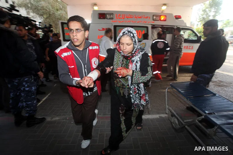 A wounded Palestinian woman arrives to Al-Shifa hospital in Gaza City on November 18, 2012. An Israeli air strike hit a Gaza City media building on November 18, injuring at least six journalists, as a separate raid in no...