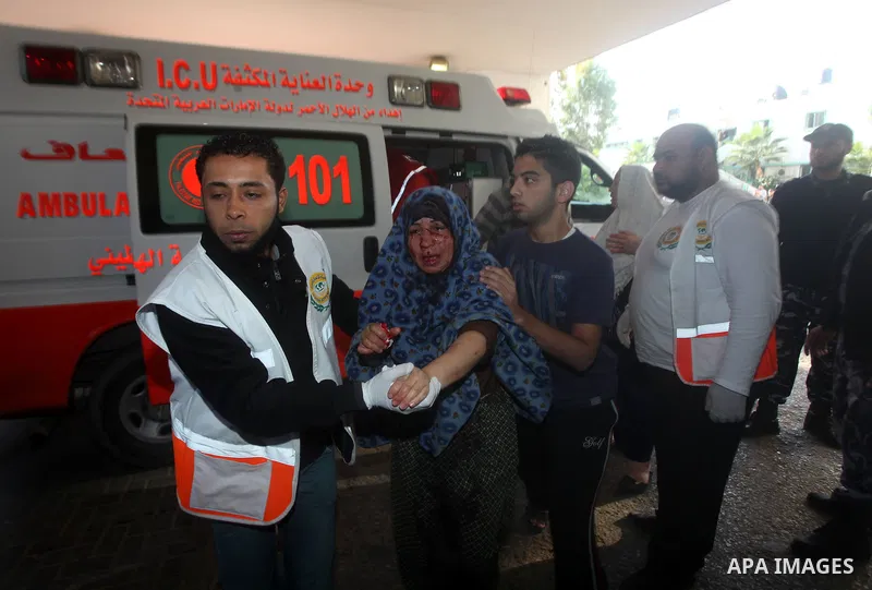 A wounded Palestinian woman arrives to Al-Shifa hospital in Gaza City on November 18, 2012. An Israeli air strike hit a Gaza City media building on November 18, injuring at least six journalists, as a separate raid in no...