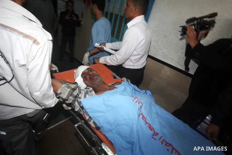Palestinian medics wheel a wounded man on a stretcher to Al-Shifa hospital in Gaza City on November 18, 2012. An Israeli air strike hit a Gaza City media building on November 18, injuring at least six journalists, as a s...