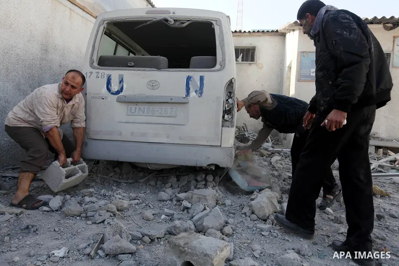 Palestinians inspect the damage at a UN Supply Center after being damaged by an Israeli airstrike directed at a Hamas police headquarters nearby in Jabalya refugee camp northern of Gaza Strip on November 18, 2012. A grou...