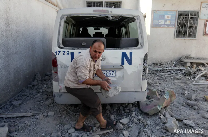 A Palestinian man inspects the damage at a UN Supply Center after being damaged by an Israeli airstrike directed at a Hamas police headquarters nearby in Jabalya refugee camp northern of Gaza Strip on November 18, 2012....