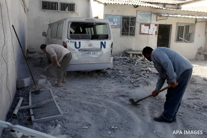 Palestinians inspect the damage at a UN Supply Center after being damaged by an Israeli airstrike directed at a Hamas police headquarters nearby in Jabalya refugee camp northern of Gaza Strip on November 18, 2012. A grou...
