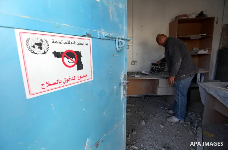 A Palestinian man inspects the damage at a UN Supply Center after being damaged by an Israeli airstrike directed at a Hamas police headquarters nearby in Jabalya refugee camp northern of Gaza Strip on November 18, 2012....