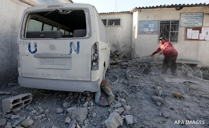 A Palestinian man inspects the damage at a UN Supply Center after being damaged by an Israeli airstrike directed at a Hamas police headquarters nearby in Jabalya refugee camp northern of Gaza Strip on November 18, 2012....