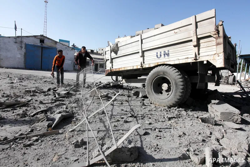 Palestinians inspect the damage at a UN Supply Center after being damaged by an Israeli airstrike directed at a Hamas police headquarters nearby in Jabalya refugee camp northern of Gaza Strip on November 18, 2012. A grou...