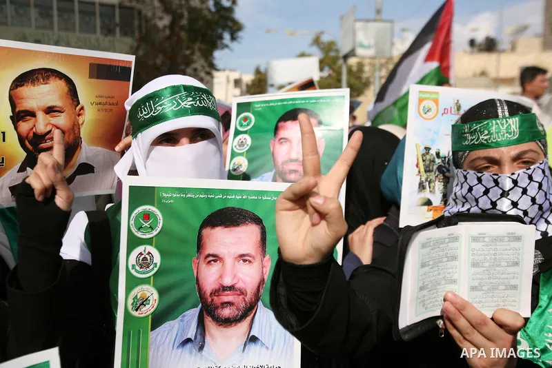 Hundreds of students from Hebron University some shouting and holding up the Palestinian flag demonstrate against the Israeli military attacks on the palestinian Gaza strip, in the West Bank town of Hebron, on November 1...