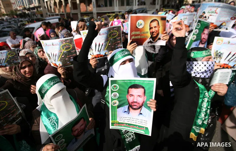 Hundreds of students from Hebron University some shouting and holding up the Palestinian flag demonstrate against the Israeli military attacks on the palestinian Gaza strip, in the West Bank town of Hebron, on November 1...