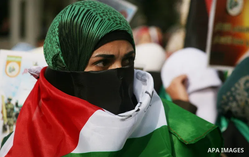 Hundreds of students from Hebron University some shouting and holding up the Palestinian flag demonstrate against the Israeli military attacks on the palestinian Gaza strip, in the West Bank town of Hebron, on November 1...