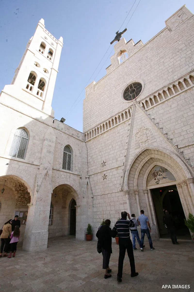 Palestinians gather at the Church of the Annunciation to pray for the children of Gaza, in the West Bank city of Beit Jala, on November 18, 2012. Israeli aircraft killed five Palestinian children in on Sunday, according...