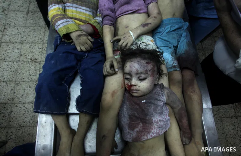 The bodies of four children from the al-Dallu family lay in a hospital after an Israeli missile struck a family home in Gaza City, on November 18, 2012. Ten Palestinian civilians were killed on Sunday in an Israeli air s...