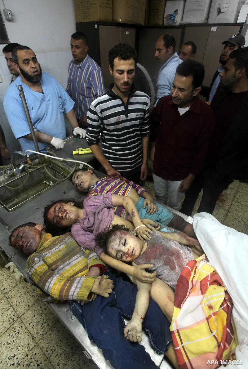 The bodies of four children from the al-Dallu family lay in a hospital after an Israeli missile struck a family home in Gaza City, on November 18, 2012. Ten Palestinian civilians were killed on Sunday in an Israeli air s...