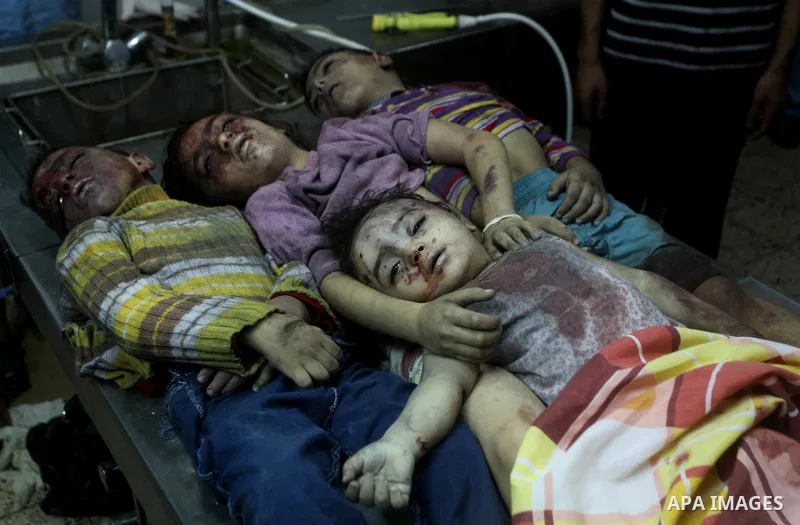 The bodies of four children from the al-Dallu family lay in a hospital after an Israeli missile struck a family home in Gaza City, on November 18, 2012. Ten Palestinian civilians were killed on Sunday in an Israeli air s...