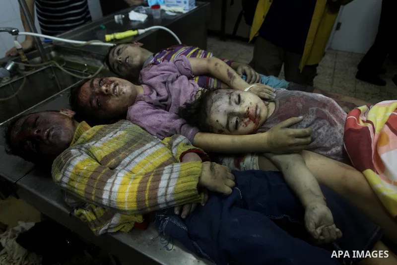 The bodies of four children from the al-Dallu family lay in a hospital after an Israeli missile struck a family home in Gaza City, on November 18, 2012. Ten Palestinian civilians were killed on Sunday in an Israeli air s...