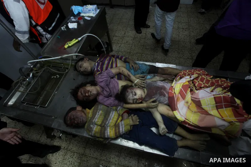 The bodies of four children from the al-Dallu family lay in a hospital after an Israeli missile struck a family home in Gaza City, on November 18, 2012. Ten Palestinian civilians were killed on Sunday in an Israeli air s...