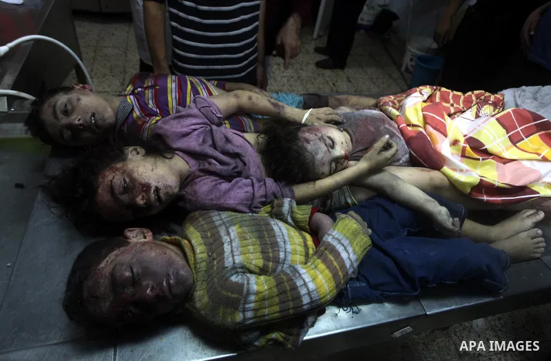 The bodies of four children from the al-Dallu family lay in a hospital after an Israeli missile struck a family home in Gaza City, on November 18, 2012. Ten Palestinian civilians were killed on Sunday in an Israeli air s...
