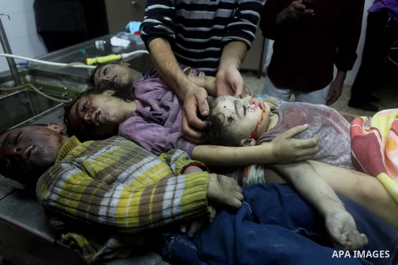 The bodies of four children from the al-Dallu family lay in a hospital after an Israeli missile struck a family home in Gaza City, on November 18, 2012. Ten Palestinian civilians were killed on Sunday in an Israeli air s...