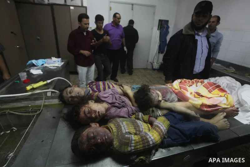 The bodies of four children from the al-Dallu family lay in a hospital after an Israeli missile struck a family home in Gaza City, on November 18, 2012. Ten Palestinian civilians were killed on Sunday in an Israeli air s...