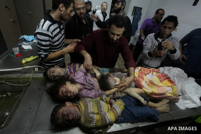 The bodies of four children from the al-Dallu family lay in a hospital after an Israeli missile struck a family home in Gaza City, on November 18, 2012. Ten Palestinian civilians were killed on Sunday in an Israeli air s...