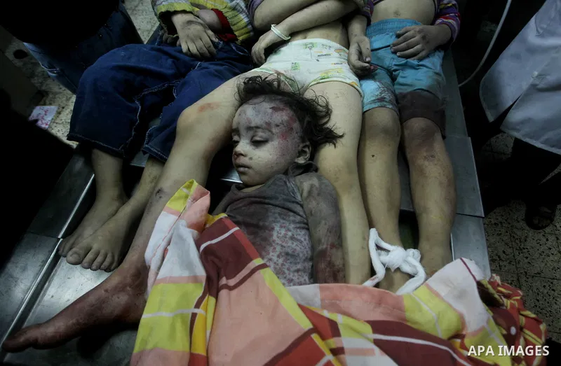 The bodies of four children from the al-Dallu family lay in a hospital after an Israeli missile struck a family home in Gaza City, on November 18, 2012. Ten Palestinian civilians were killed on Sunday in an Israeli air s...